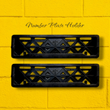 Two black number plate holders on a yellow background car number plate frame 